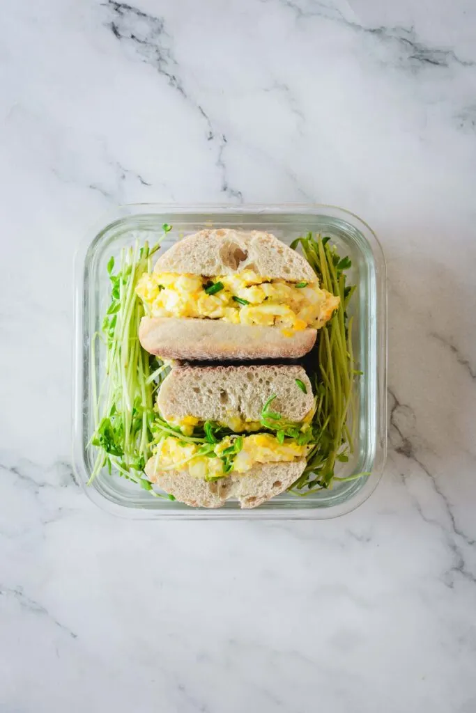 Egg salad sandwich inside a storage container ready for a road trip