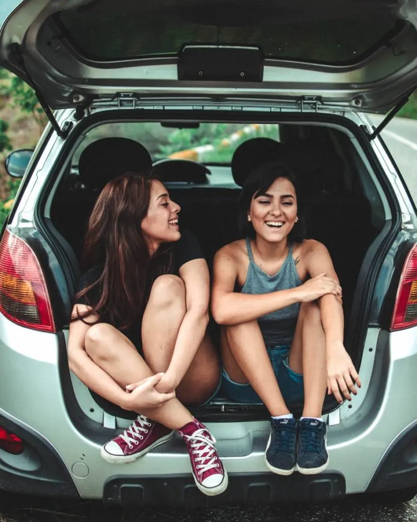 Two girls in a car having a road trip conversation