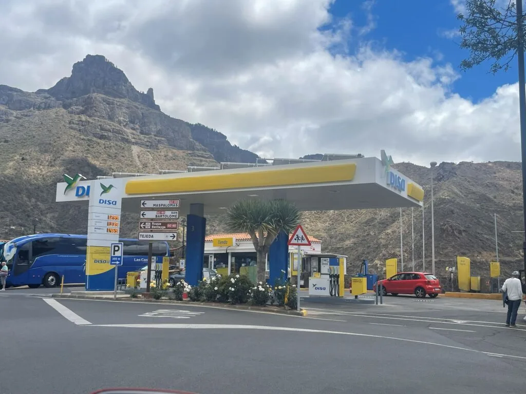 a gas station with mountains in the background