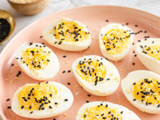 deviled eggs on a pink plate.