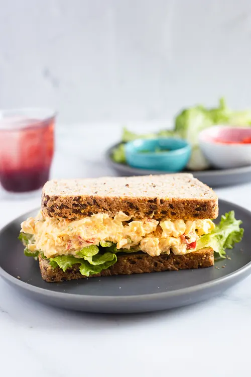 Spicy Chickpea Sandwich on a plate with juice and sauces