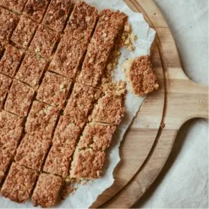 Flapjacks presented on a chopping board and sliced into portions