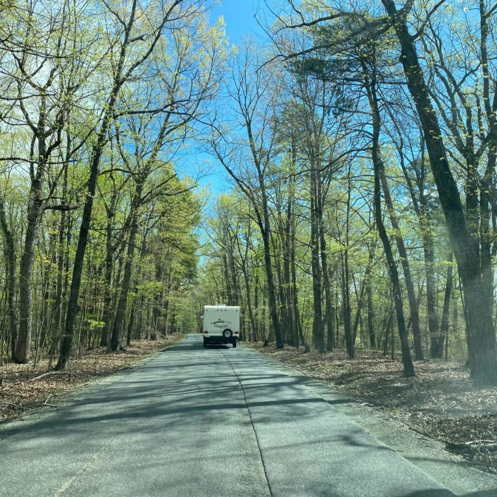 a photo of the road with trees either side and our rv shown in front