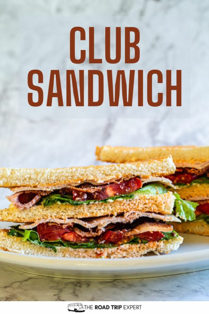 Club sandwich on a plate sliced in half and presented