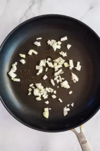 Frying the onions for the make ahead breakfast burritos in a non stick pan