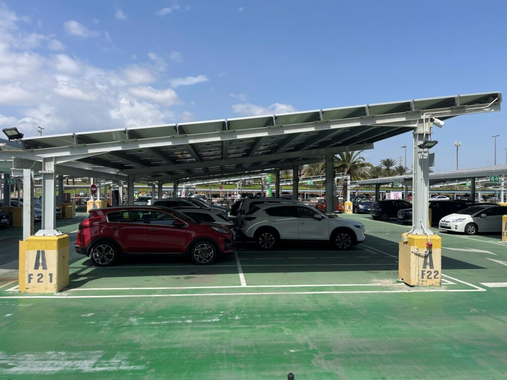 Cars parked in sheltered car park spaces